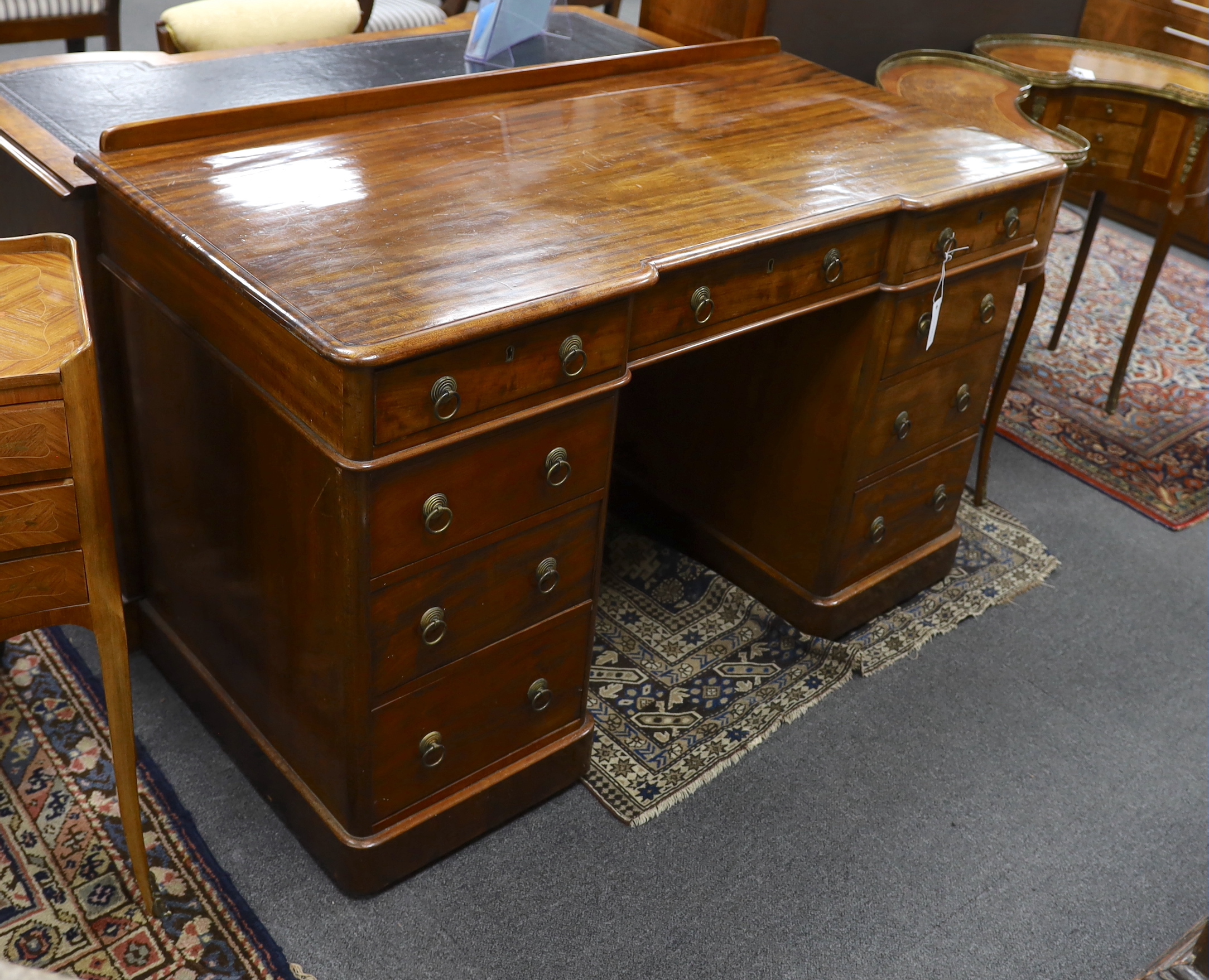 A Victorian mahogany Heal & Son, London inverse breakfront pedestal desk, width 122cm, depth 59cm, height 76cm